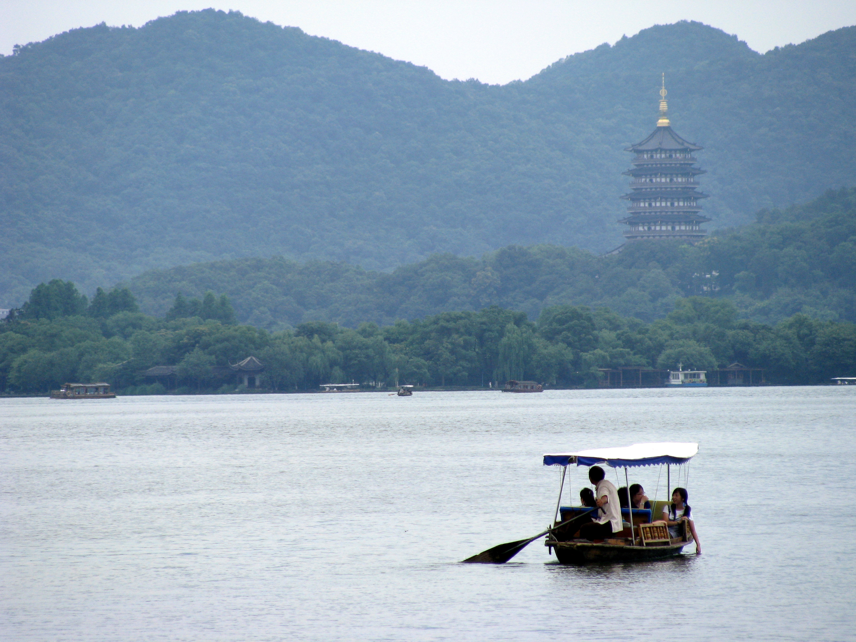 A rowboat and Leifeng Pagoda across West Lake, Hangzhou